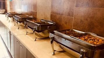 A buffet line with multiple food service stations.