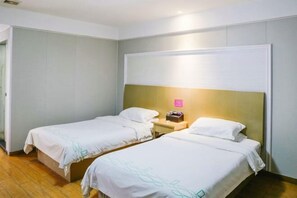 A hotel room with two single beds, a nightstand, and a wall-mounted light. - Qingjiang Express Hotel (Zhangshu)