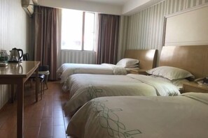 A hotel room with two beds, a desk with a kettle, and a window with curtains. - Qingjiang Express Hotel (Zhangshu)