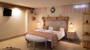 A bedroom with a large bed, bedside tables, a TV, and a wooden headboard. - 3888 Villetta tra Mari e Monti by Barbarhouse (San Giovanni Rotondo)