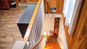 A wooden staircase with a white railing leading to a landing. - DLT Cabins, LLC - Holler Hideaway Cozy house sleeps 4 on 10 Minutes from SNP (Luray)