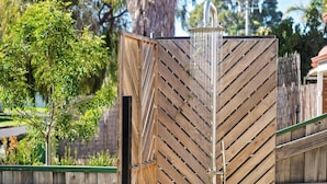 A wooden fence with diagonal slats and a metal structure on top. - Luna Getaway—Spacious Family Escape by the Coast (Quindalup)