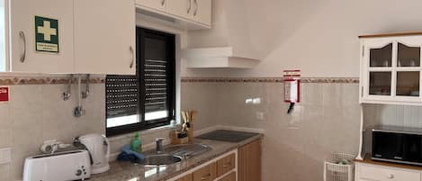 Fridge, microwave, stovetop, coffee/tea maker
