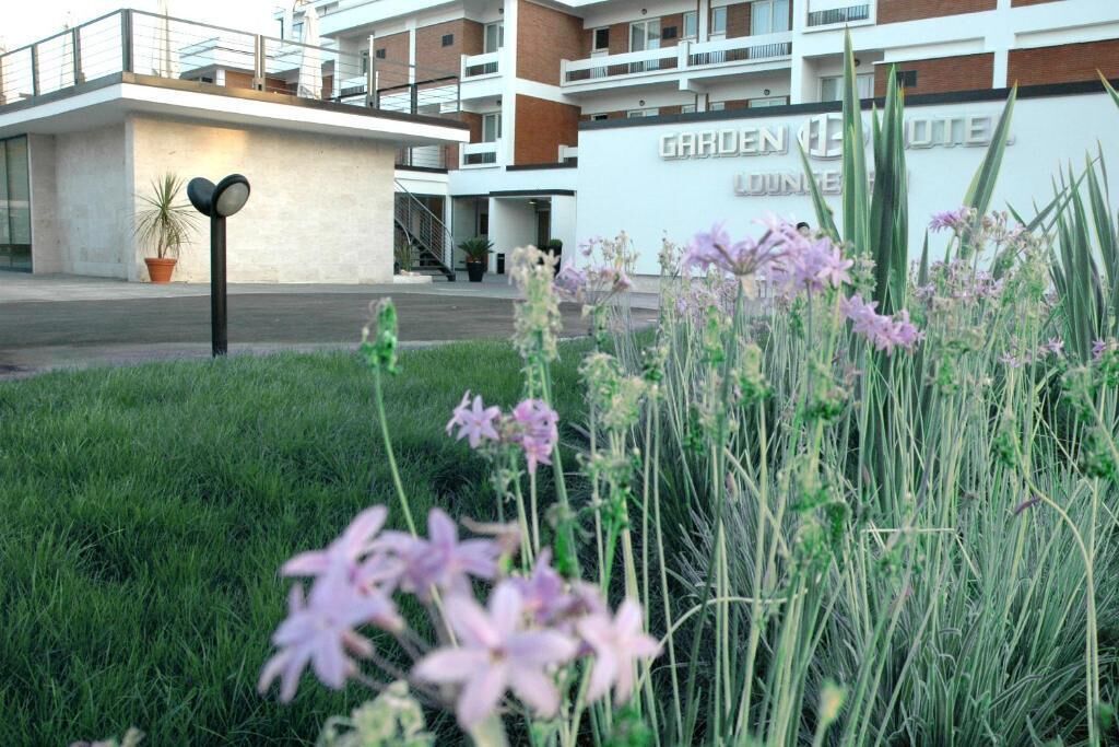 A modern building with a sign reading "Garden Hotel."