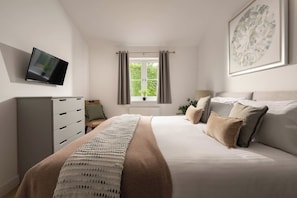 A bedroom with a bed, a television on the wall, a window with curtains, and a plant.
