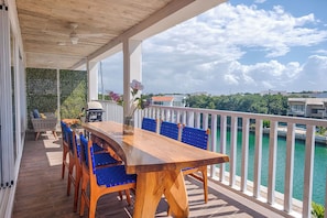 Enjoy dining and socializing in this scenic outdoor space with a grill and water views.