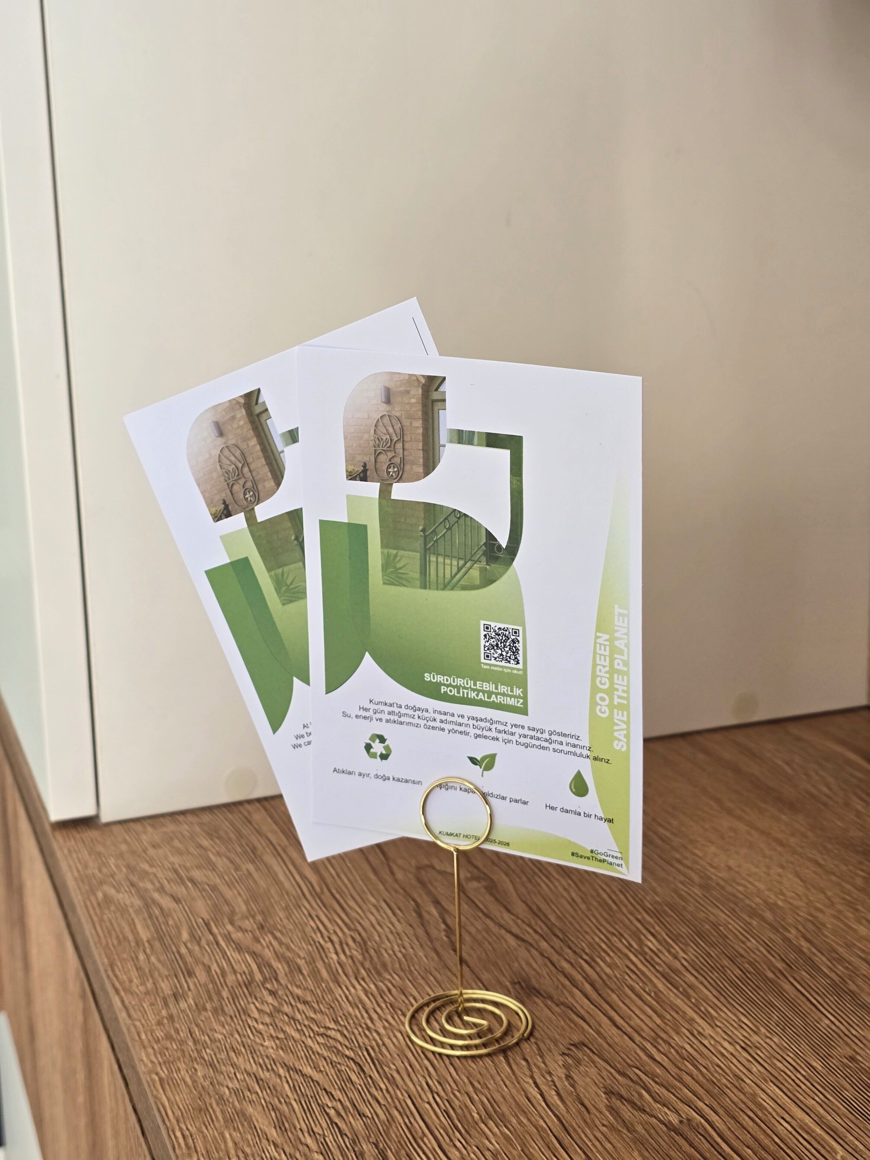 A promotional flyer for a hotel with a QR code and text about sustainability.