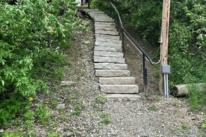 A stone staircase leading uphill surrounded by greenery.