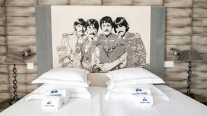 A bed with white bedding and two pillows, each labeled "Surfers Lodge." - Surfers Lodge Peniche (Peniche)