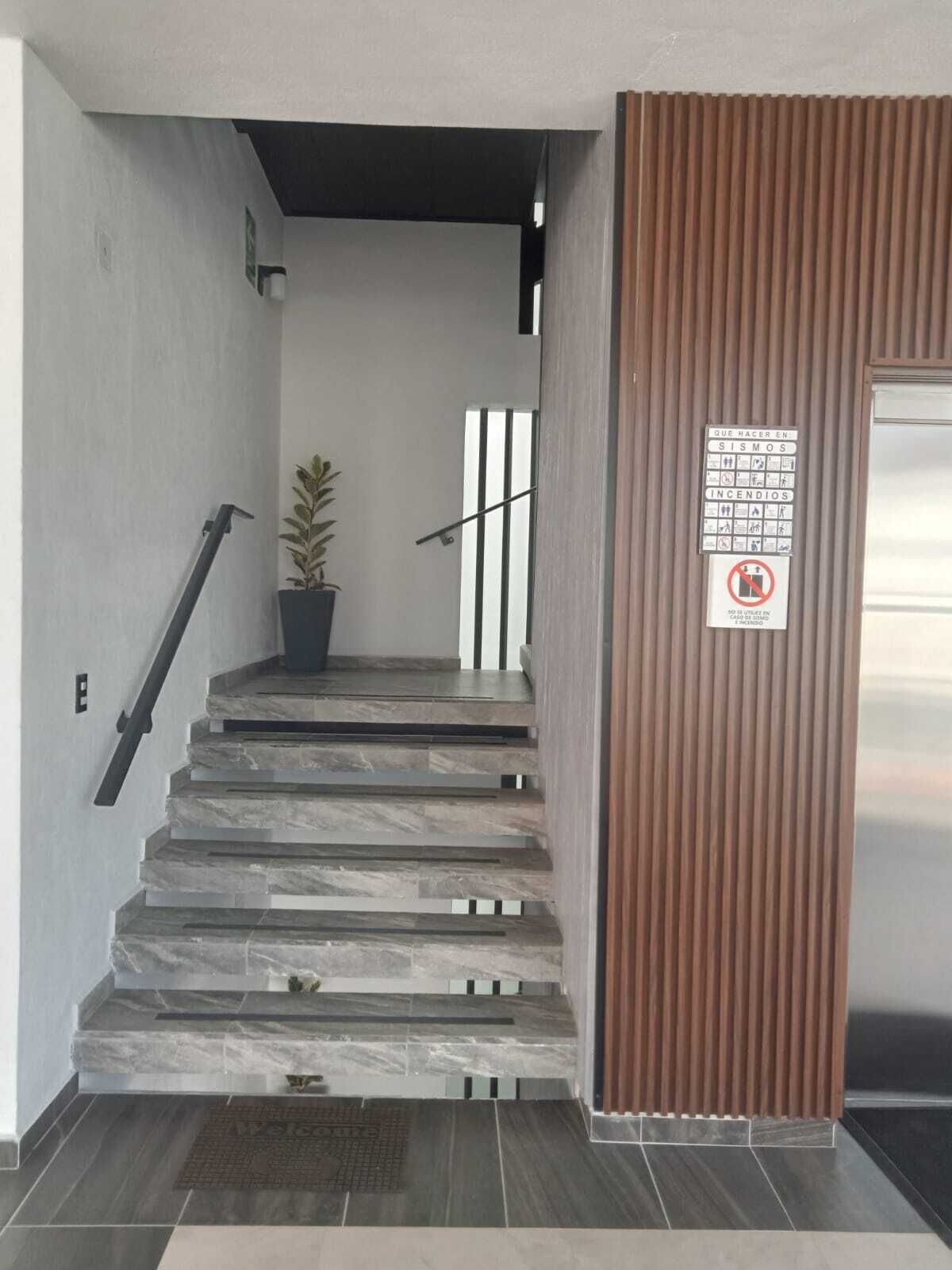 A staircase with stone steps leading to a landing.