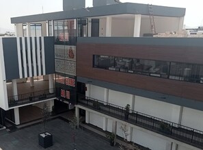 A modern hotel with a two-story structure, balconies, and a visible entrance. - MONARCA HOTEL & PLAZA  (Atlacomulco)