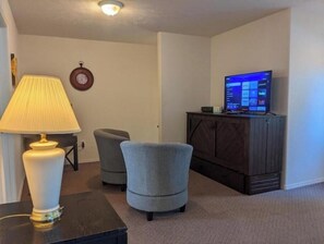 Relax in this cozy space with a comfortable armchair and flat-screen TV.
