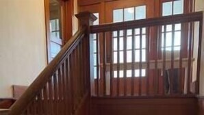 A wooden staircase with a railing leading to a lower level. - The Historic Downtown Astoria Flats (Astoria)