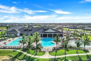 A large resort with multiple swimming pools, a central building, and surrounding greenery. - Vacation in Paradise! (Fort Myers)