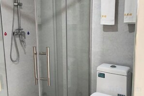 A bathroom with a glass shower enclosure, a toilet, and towels hanging on the wall. - Harmony Harbour Hotel (Sixin Avenue Subway Station Hancheng Garden ) (Wuhan)