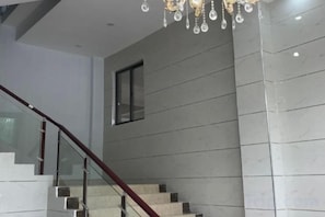 A modern staircase with glass railings and a chandelier. - Harmony Harbour Hotel (Sixin Avenue Subway Station Hancheng Garden ) (Wuhan)