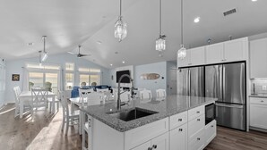 A spacious kitchen with white cabinetry, a granite countertop, and stainless steel appliances. - Soundfront 10BR with Pool & Hot Tub- Perfect for Large Groups ★★★★★ (Avon)