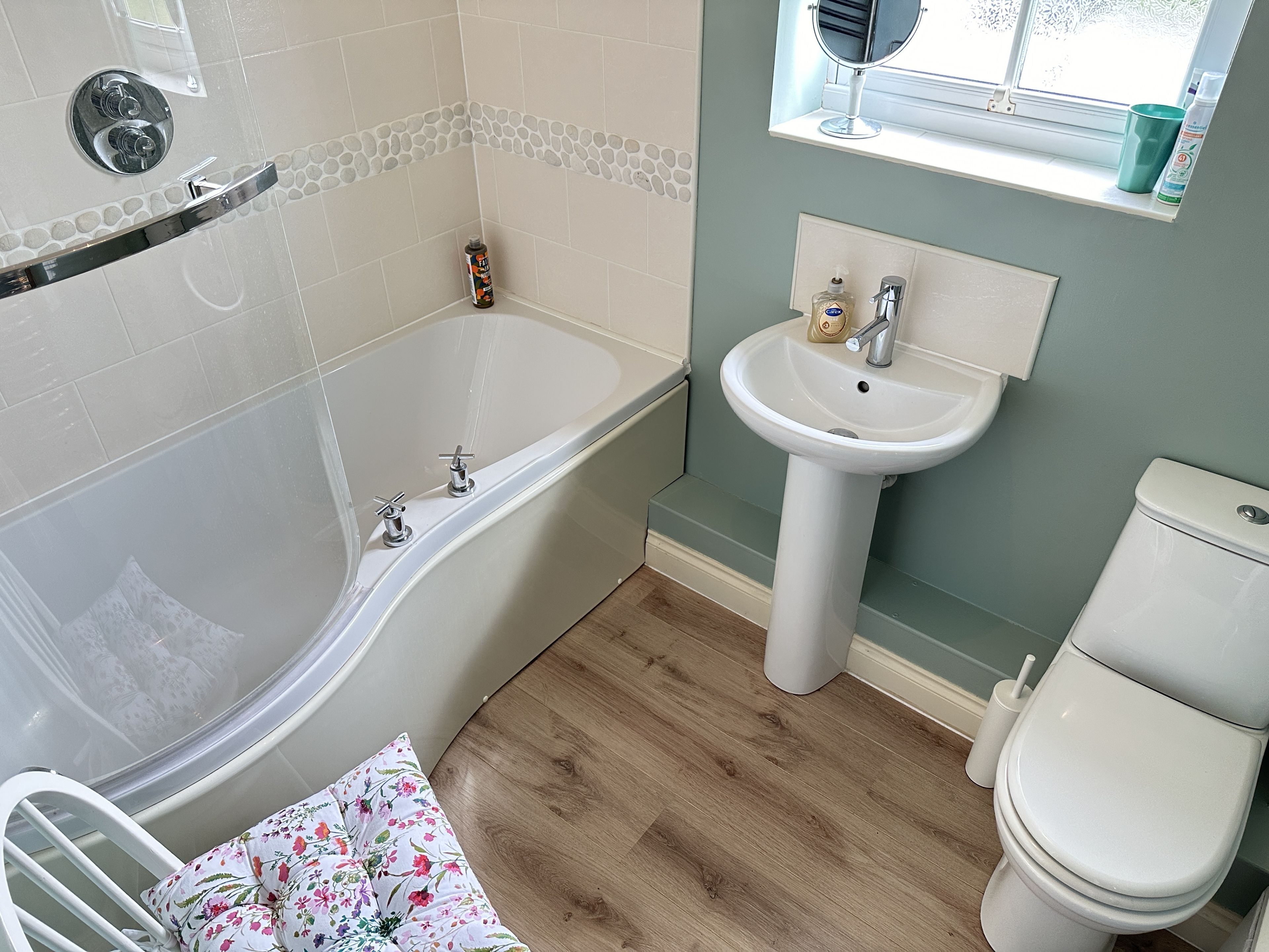 A bathroom with a bathtub, a sink, and a toilet.