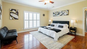 A bedroom with a bed, a chair, a ceiling fan, and artwork on the walls. - Chattanooga Valley Paradise | Pickleball | Pool (flintstone)