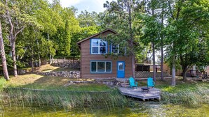 A cabin with a dock, surrounded by trees and a pond. - Cabin #6 - Loons' Nest (Lake Emma Township)