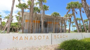 A building with the sign "Manasota Beach" in front. - Seaclusion - stunning bayfront home with pool (Englewood)