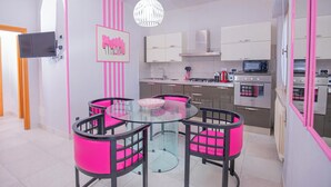 A modern kitchen with white cabinets, a microwave, and an oven. - Seaside apartment in Bengodi (Orbetello)