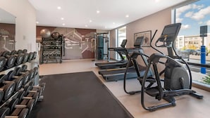 A gym with treadmills, dumbbells, and exercise balls. - Cambria Hotel & Suites Plymouth (Plymouth)