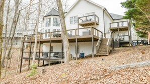 A two-story house with a balcony and a deck. - Spacious Lake House with Dock and Swimming Pool (Dawsonville)