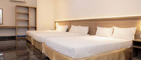 A hotel room with two beds, a wooden wardrobe, a ladder, and a marble floor.