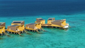 Overwater bungalows with solar panels, connected by walkways, in clear turquoise waters. - Centara Mirage Lagoon Maldives (Kodhipparu Falhu)