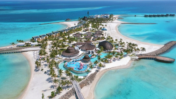 An aerial view of a resort with overwater bungalows, a beach, and a swimming pool. - Centara Mirage Lagoon Maldives (Kodhipparu Falhu)