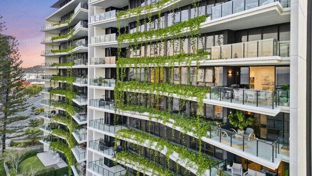 A multi-story hotel with balconies covered in greenery, a modern architectural design, and a view of the surrounding landscape. - Magnoli Apartments  (Palm Beach)