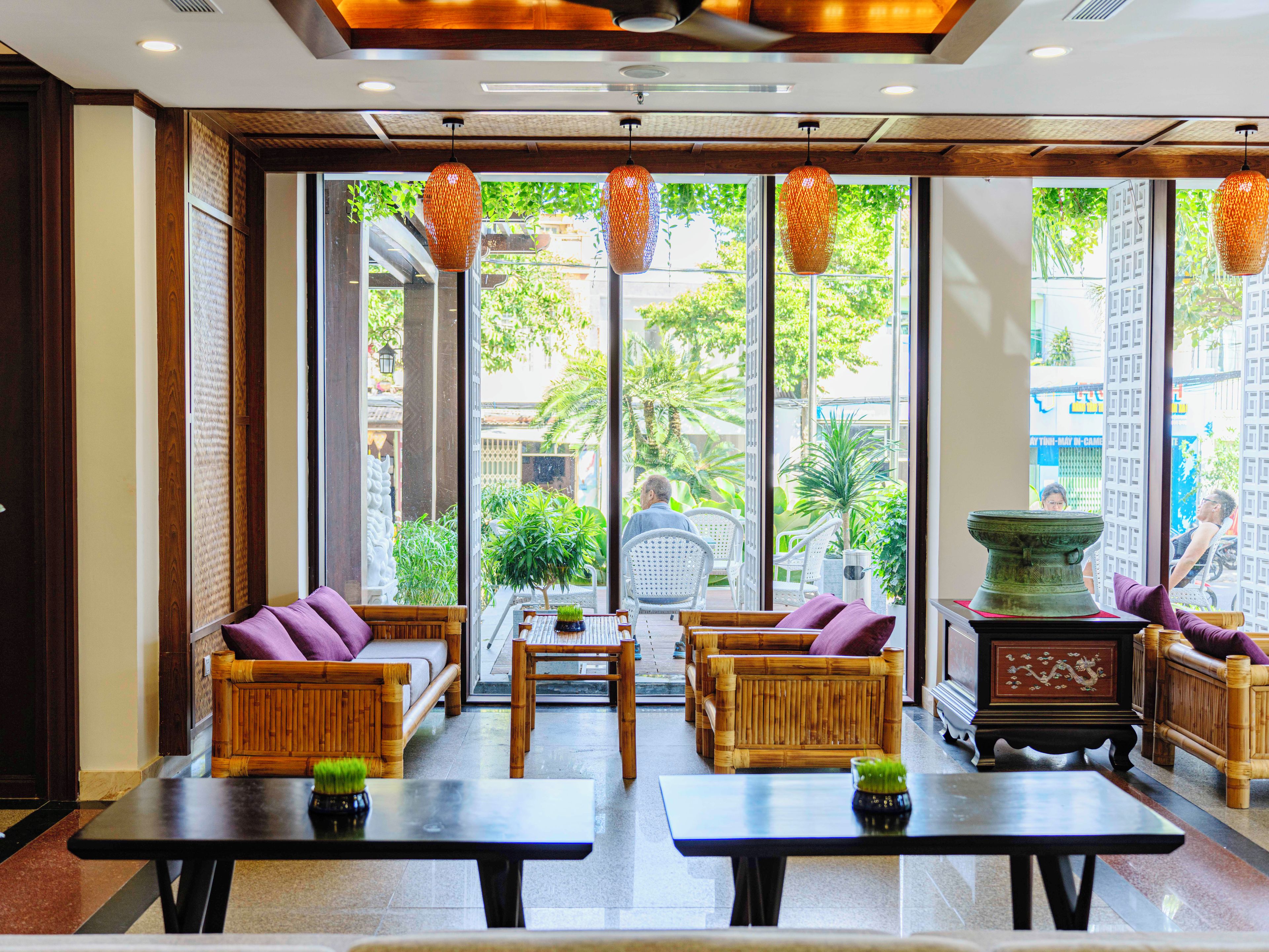 A spacious lobby with a seating area, large windows, and a view of the outside.