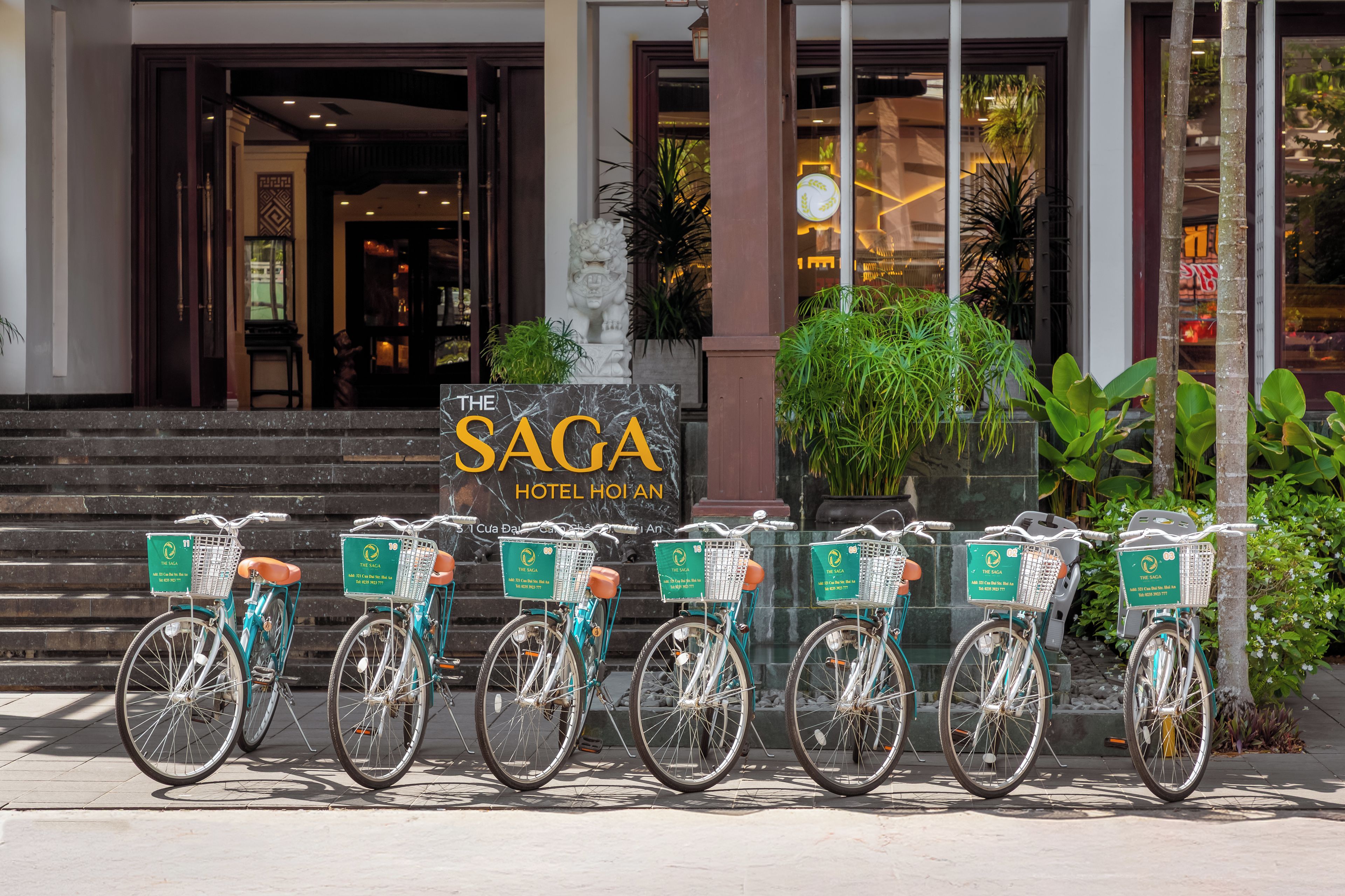 A hotel entrance with a sign for 'The Saga Hotel Hoian'.