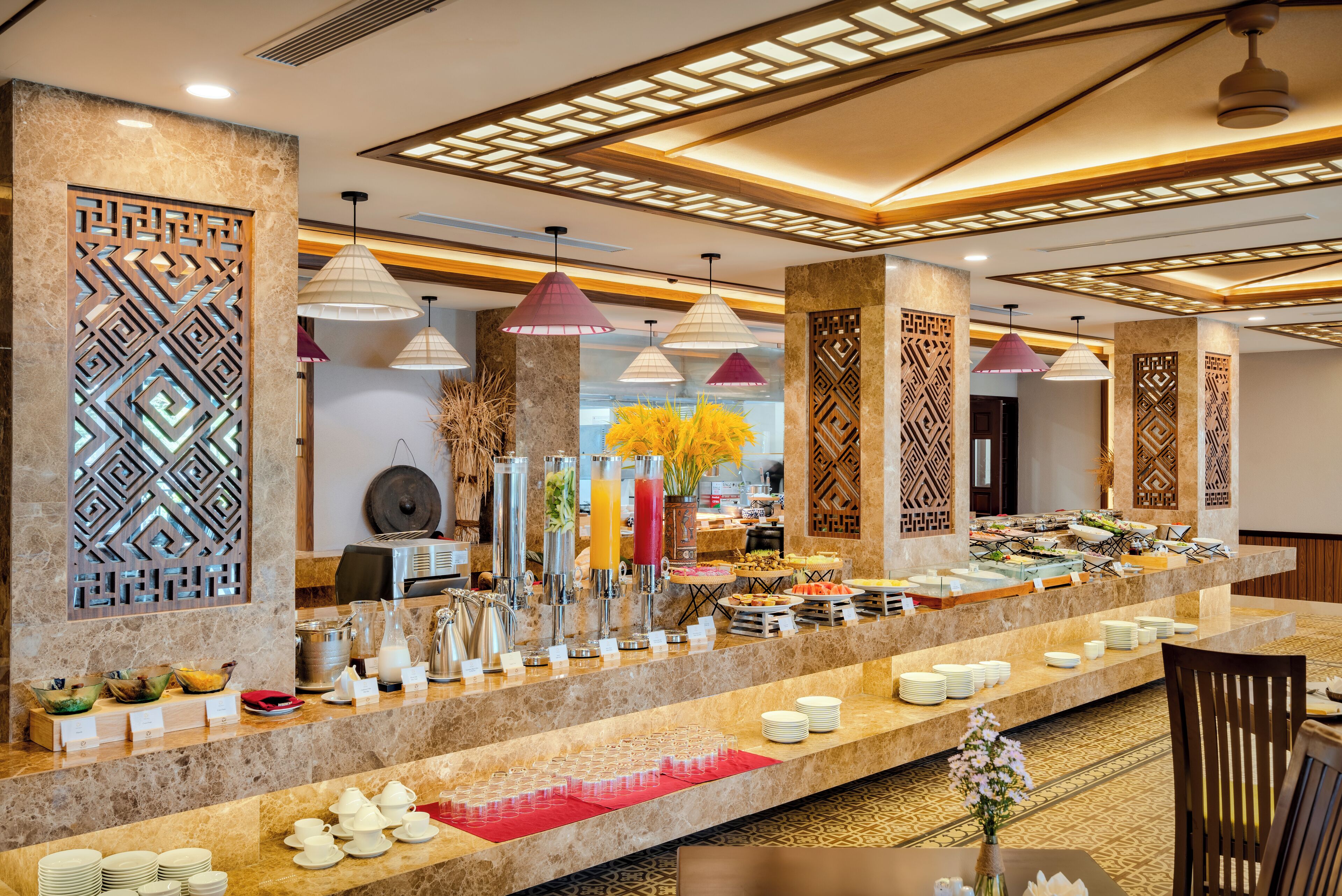 A buffet area with a marble counter, various food items, and decorative lighting.