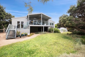 A two-story house with a covered patio and a staircase leading to the upper level. - Coastwalk (Aireys Inlet)