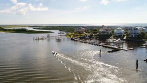A marina with boats, a pier, and houses in the background. - Adorable Beach Cottage,1 Block from Beach + Kure Beach Pier, Dog Friendly with Fence (Kure Beach)