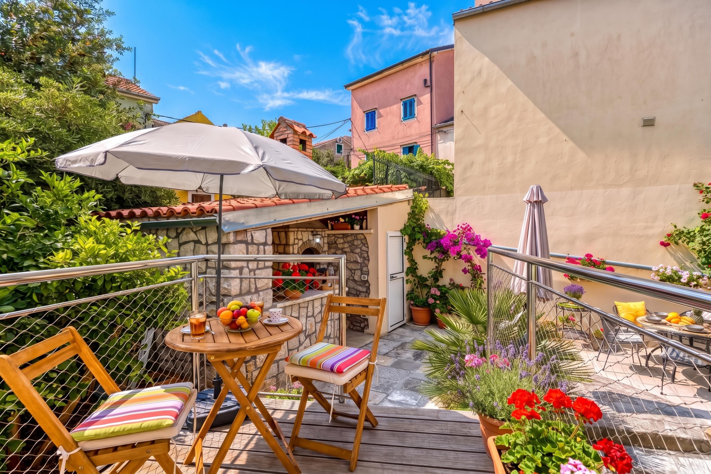 A patio with a table, chairs, and a large umbrella.