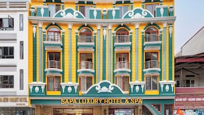 A building with a sign reading "SPA LUXURY HOTEL & SPA".