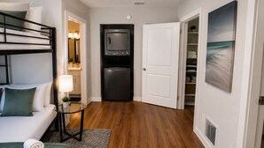 A compact hotel room with a bunk bed, a kitchenette, a small dining area, and a closet with shelves. - Ocean Breeze Bungalow 4BR 2BA W/Pool (Hollywood)