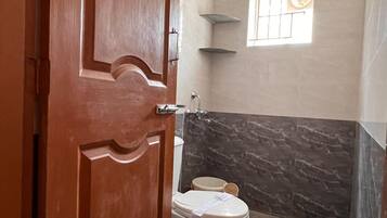 Deluxe Triple Room, Private Bathroom | Bathroom | Shower, towels, soap, shampoo