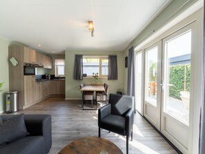 Enjoy a spacious kitchen with modern appliances and dining area near a large window offering a view of the outdoors.