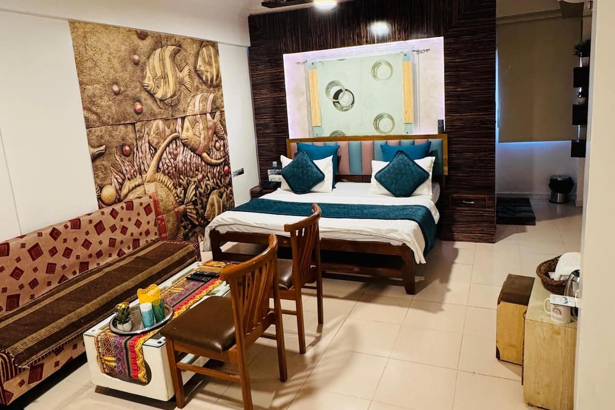 Un dormitorio con cama, escritorio, silla, alfombra y una pared con diseño decorativo.