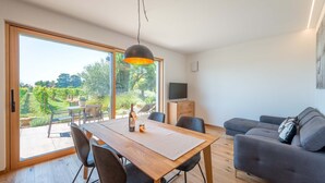 Un salon moderne comprenant un coin repas, un canapé et un téléviseur.