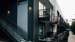 A modern building with a staircase, a balcony, and outdoor seating. - Bright Studio Near Rainey St / Mins to DT ATX (Austin)