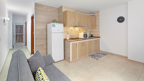A modern kitchen with wooden cabinets, a refrigerator, and a microwave. - Vacation Apartment 'Danoe 3' with Wi-Fi (Mogán)