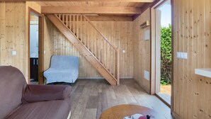 A wooden interior with a staircase, a sofa, and a view through a door. - Holiday Home 'Casa El Mirlo' with Private Pool, Wi-Fi and Air Conditioning (Conil de la Frontera)