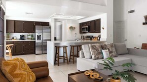 A modern kitchen with dark cabinets, a stainless steel refrigerator, and a central island with stools. - Sleeps 18 | Beautiful Resort Style | Heated Pool (Scottsdale)
