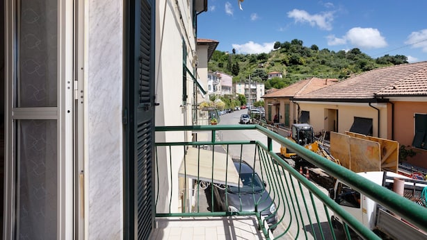 A balcony with a view of a street, buildings, and a hill. - Apartment 'Da Ercolino' with Sea View, Balcony and Wi-Fi (Pitelli)