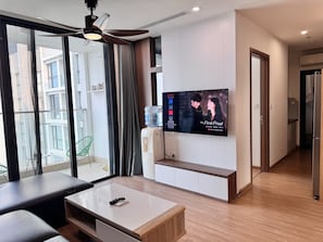 Standard Apartment, 3 Bedrooms | Living area | 65-inch flat-screen TV with satellite channels, fireplace - Mira Housing- Vinhome Skylake Luxury Apartment  (Hanoi)